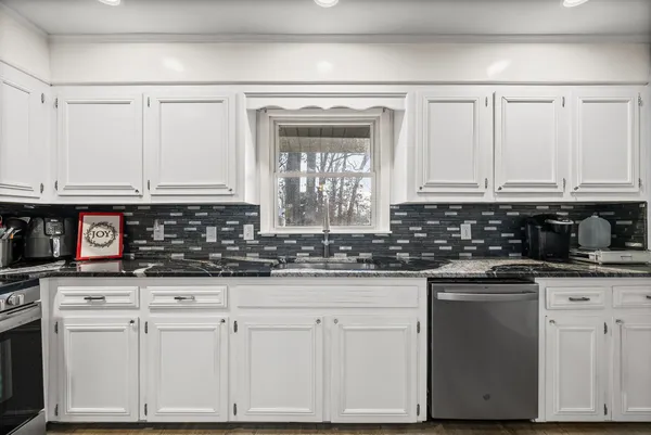 a kitchen with stainless steel appliances granite countertop a sink and cabinets