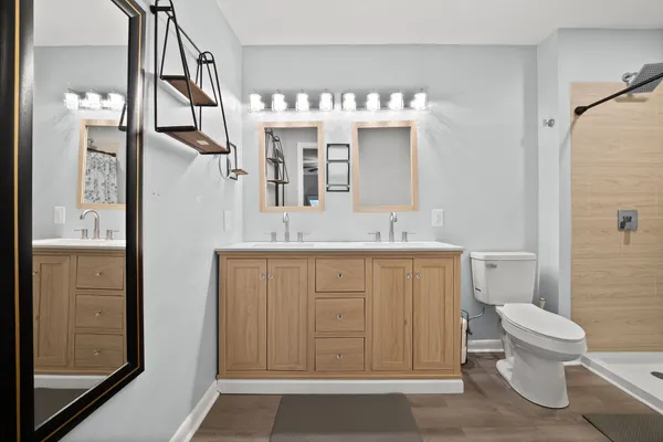 a bathroom with a sink a toilet and shower