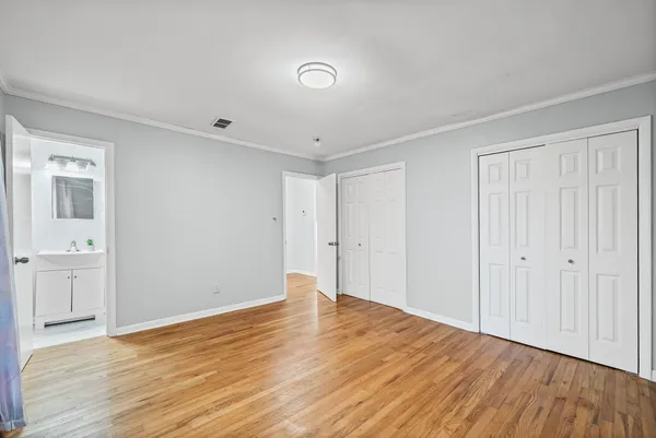 a view of an empty room with wooden floor