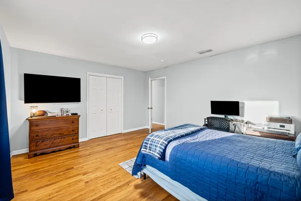 a bedroom with a bed and a flat screen tv
