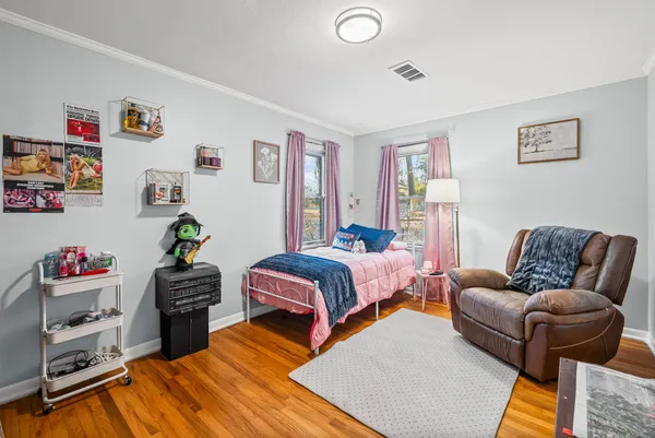 a bedroom with a bed and a couch