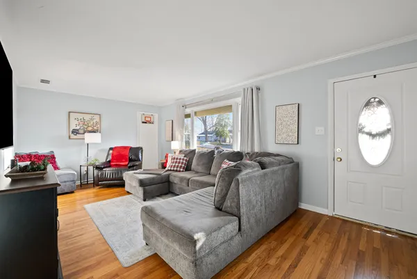 a living room with furniture and wooden floor