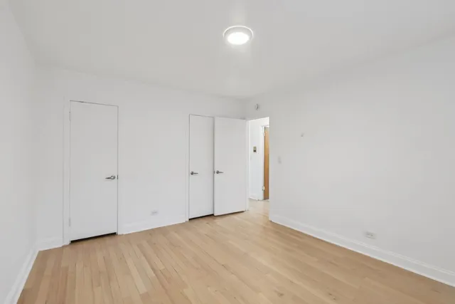 a view of an empty room and wooden floor