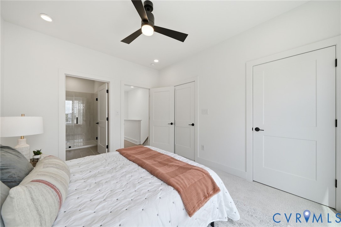 606 Decatur Street Richmond, VA 23224 - Photo 20 of 24 a bedroom with a bed and a chandelier