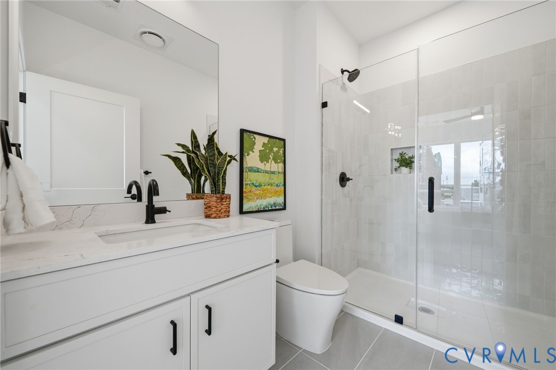 606 Decatur Street Richmond, VA 23224 - Photo 21 of 24 a bathroom with a sink a toilet and shower