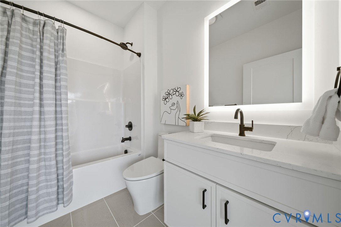 606 Decatur Street Richmond, VA 23224 - Photo 23 of 24 a bathroom with a sink a toilet and shower