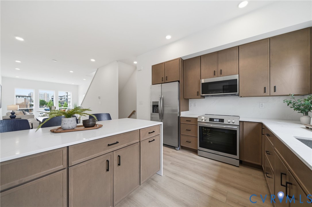 606 Decatur Street Richmond, VA 23224 - Photo 9 of 24 a kitchen with stainless steel appliances white cabinets sink and stove