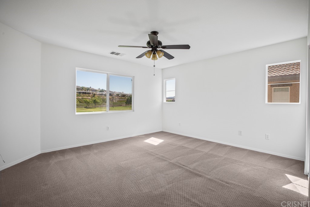 24063 Tango Drive Valencia, CA 91354 - Photo 27 of 46 an empty room with windows and fan