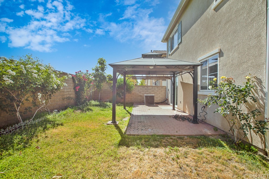 24063 Tango Drive Valencia, CA 91354 - Photo 35 of 46 a view of yellow house with a yard