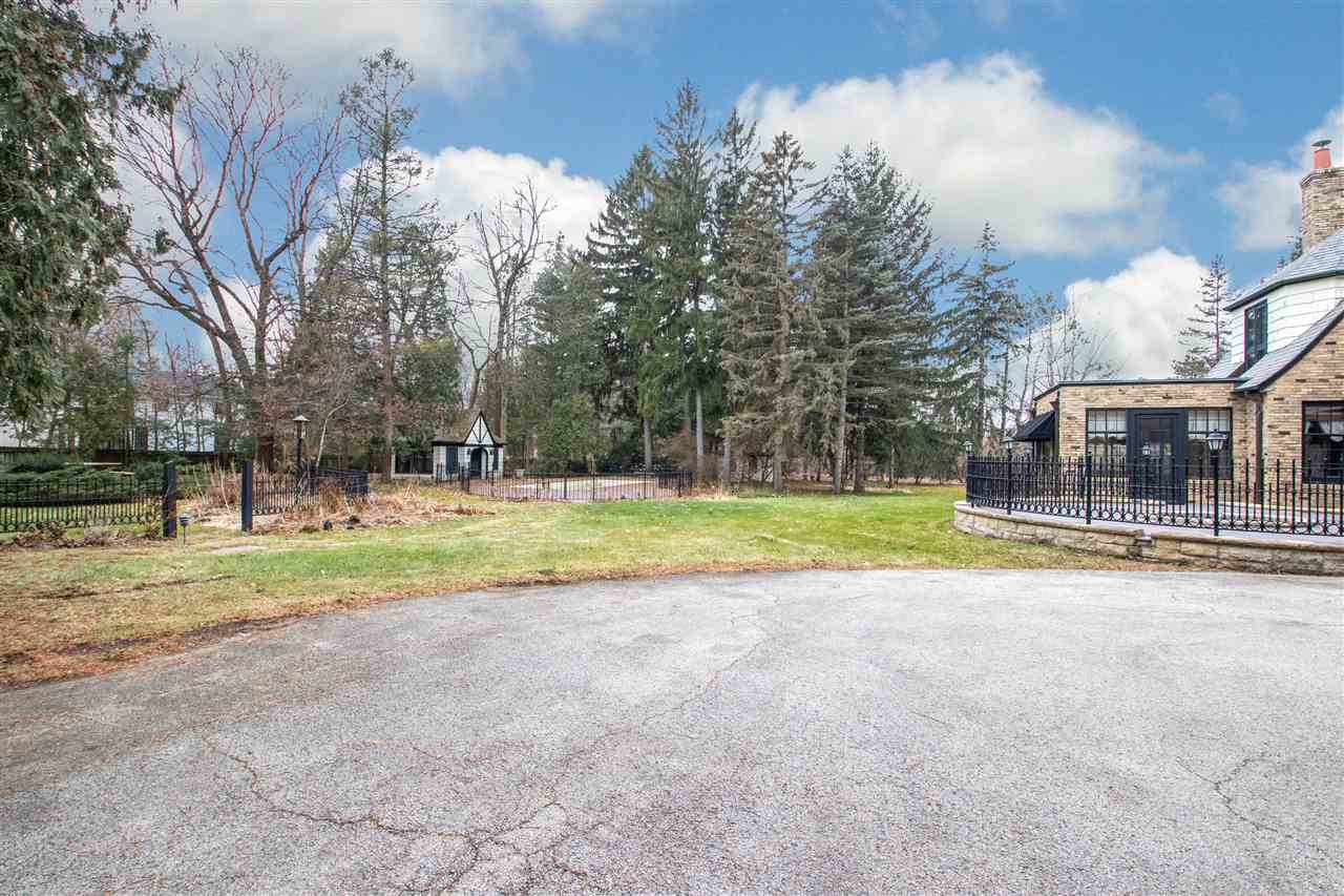 311 Spring Creek Road Rockford, IL 61107 - Photo 25 of 25 a view of a house with a big yard and a large tree