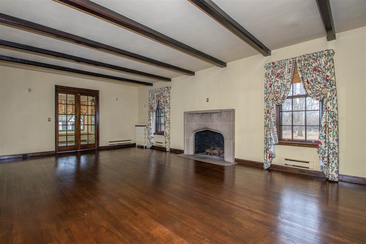 311 Spring Creek Road Rockford, IL 61107 - Photo 5 of 25 a view of empty room with fireplace wooden floor and windows