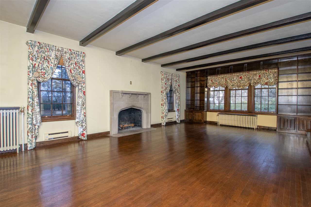 311 Spring Creek Road Rockford, IL 61107 - Photo 6 of 25 a view of empty room with wooden floor and fireplace