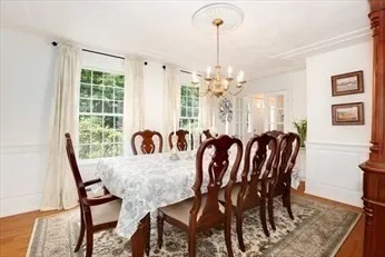 a view of a dining room that has a table chairs and chandelier