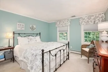 a bedroom with a bed a table and chair