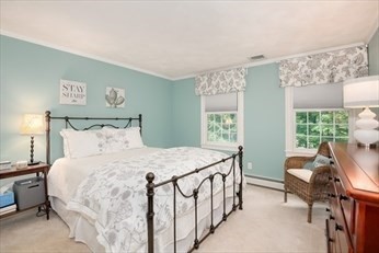 117 Perkins Row Topsfield, MA 01983 - Photo 20 of 25 a bedroom with a bed a table and chair