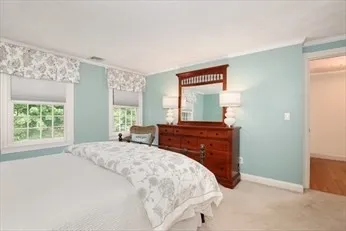 a bed sitting in a bedroom next to a window