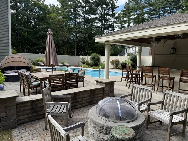 a view of a patio with a dining table and chairs