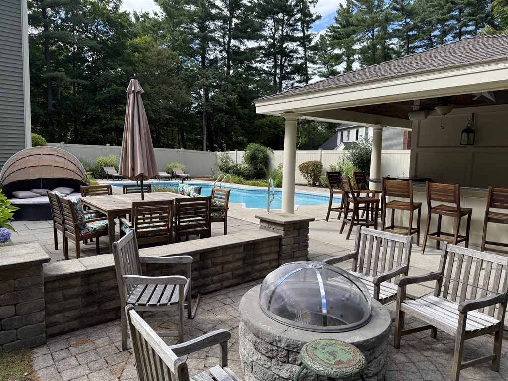 117 Perkins Row Topsfield, MA 01983 - Photo 3 of 25 a view of a patio with a dining table and chairs