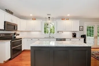 a kitchen with a sink stove top oven and microwave