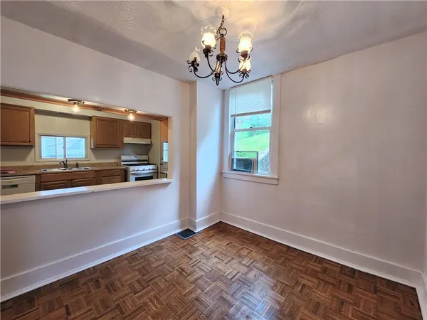 a view of a kitchen with a stove cabinets and a wooden floor