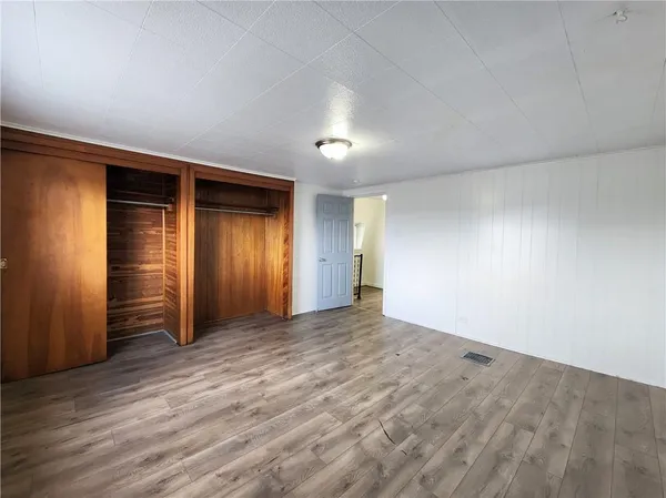 an empty room with closet area