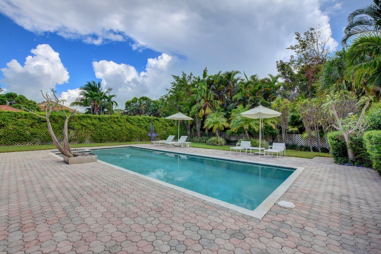 5758 Northwest 24th Terrace Boca Raton, FL 33496 - Photo 3 of 35 a view of a swimming pool with a patio and plants