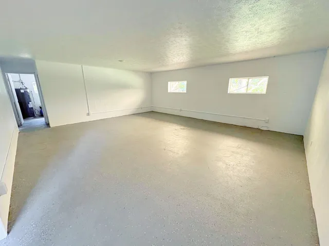 an empty room with a windows and closet