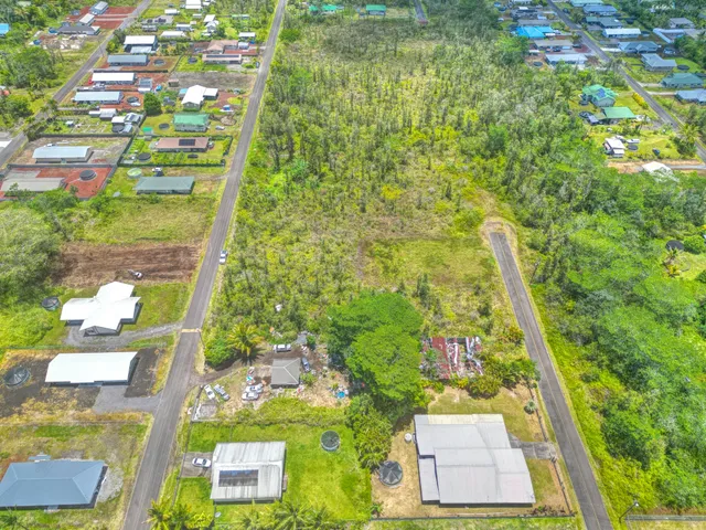 a view of a kitchen with a fridge and window