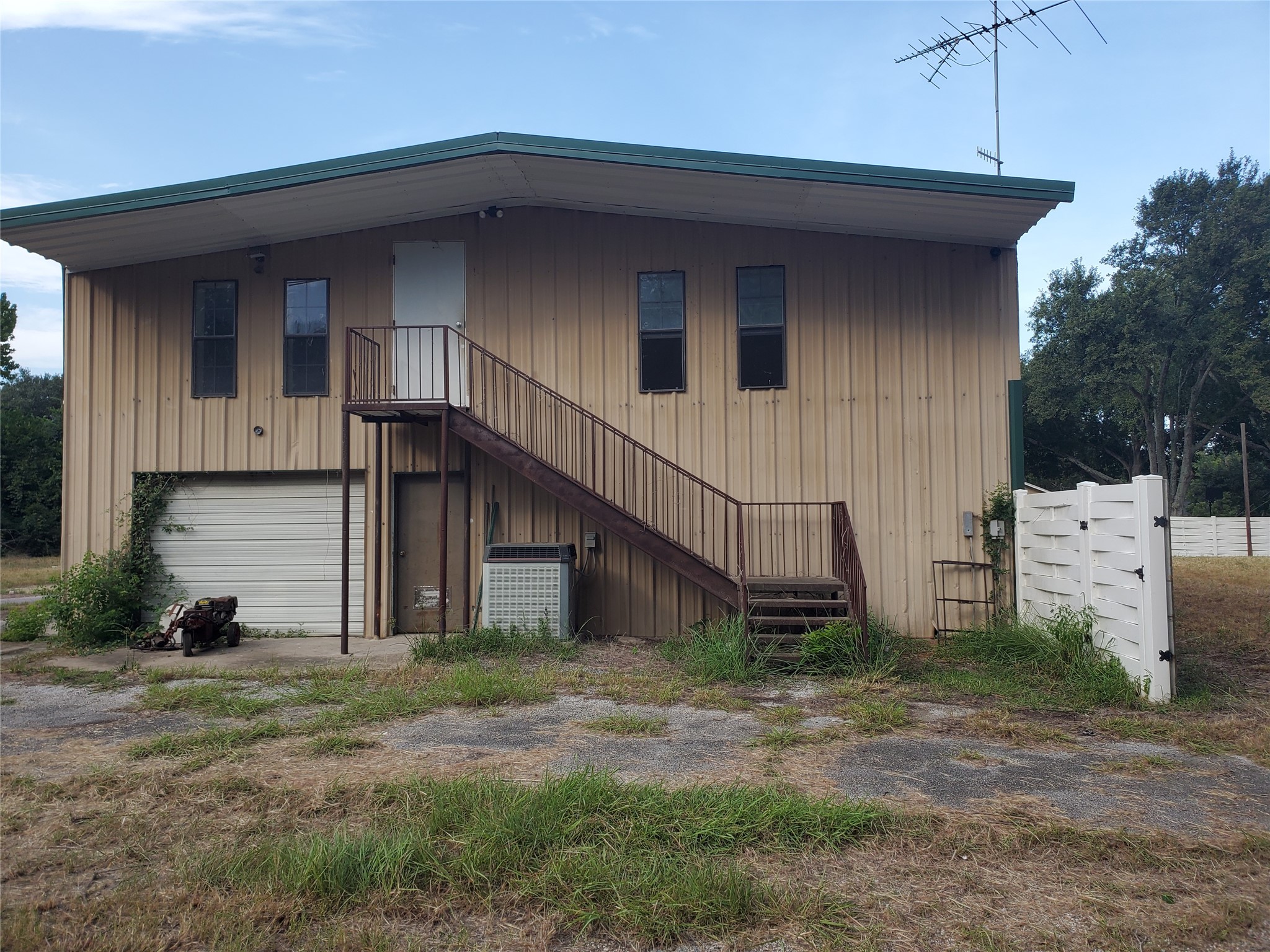 25121 Lakeview Road, Unit A Katy, TX 77494 - Photo 1 of 14 40' wide, showing second garage door and upstairs to build out area. There is also a second stairs inside the building.l
