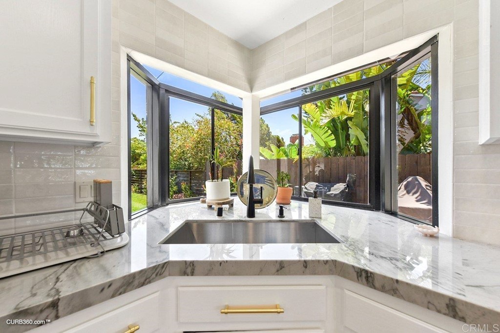 3815 Trieste Drive Carlsbad, CA 92010 - Photo 12 of 24 a kitchen with granite countertop a sink and a counter top space