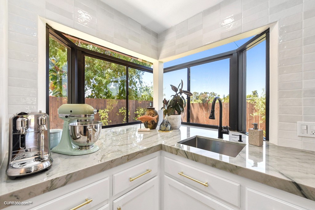 3815 Trieste Drive Carlsbad, CA 92010 - Photo 13 of 24 a kitchen with sink and large window