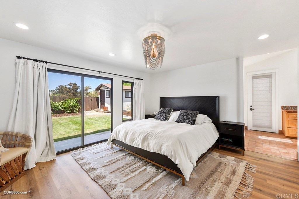 3815 Trieste Drive Carlsbad, CA 92010 - Photo 14 of 24 a bedroom with a large bed and a window