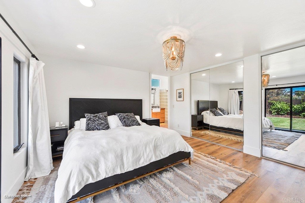 3815 Trieste Drive Carlsbad, CA 92010 - Photo 15 of 24 a bedroom with bed and a chandelier