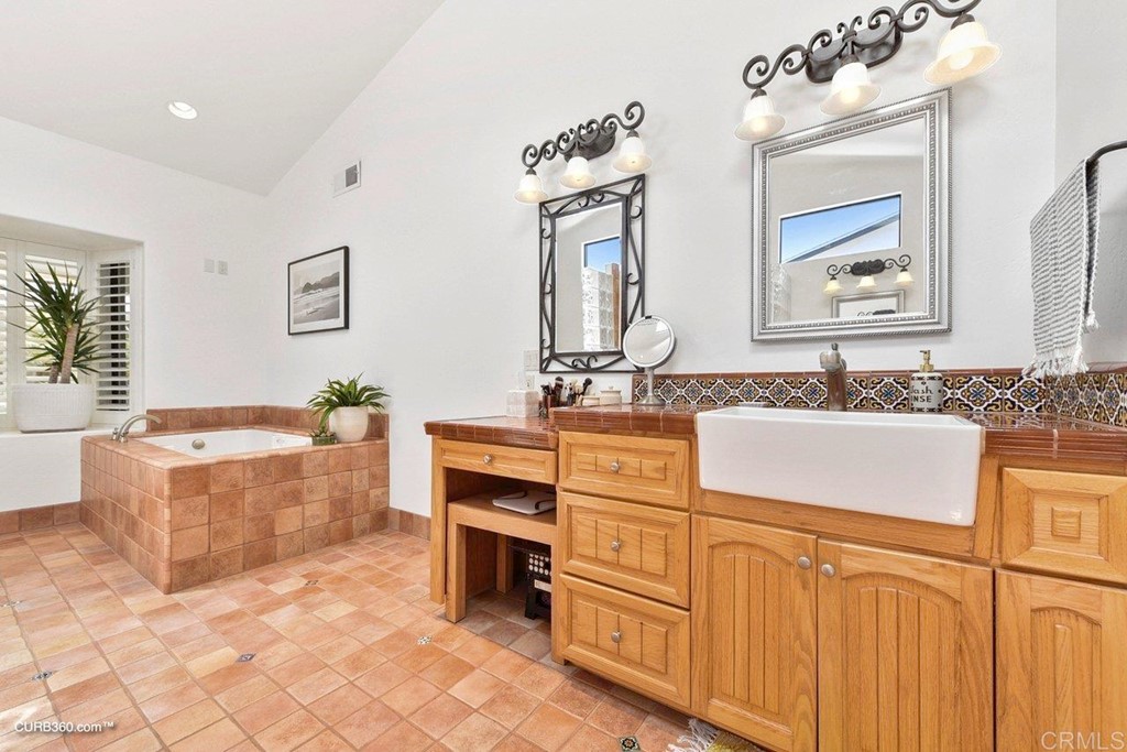 3815 Trieste Drive Carlsbad, CA 92010 - Photo 16 of 24 a bath room with a sink and a mirror