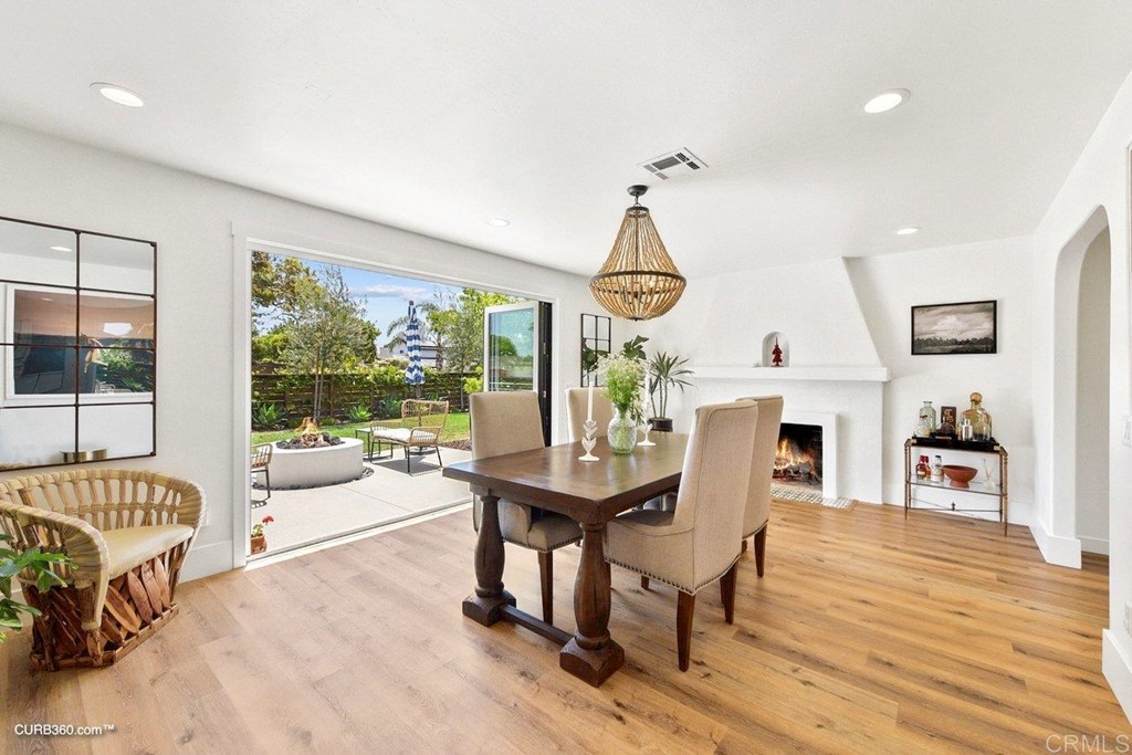 3815 Trieste Drive Carlsbad, CA 92010 - Photo 2 of 24 a view of a dining room with furniture a chandelier and wooden floor
