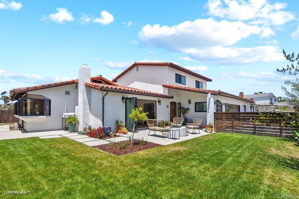 3815 Trieste Drive Carlsbad, CA 92010 - Photo 23 of 24 a front view of a house with garden and sitting area
