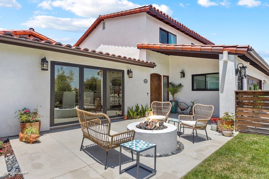 3815 Trieste Drive Carlsbad, CA 92010 - Photo 3 of 24 a view of a patio with couches table and chairs and potted plants