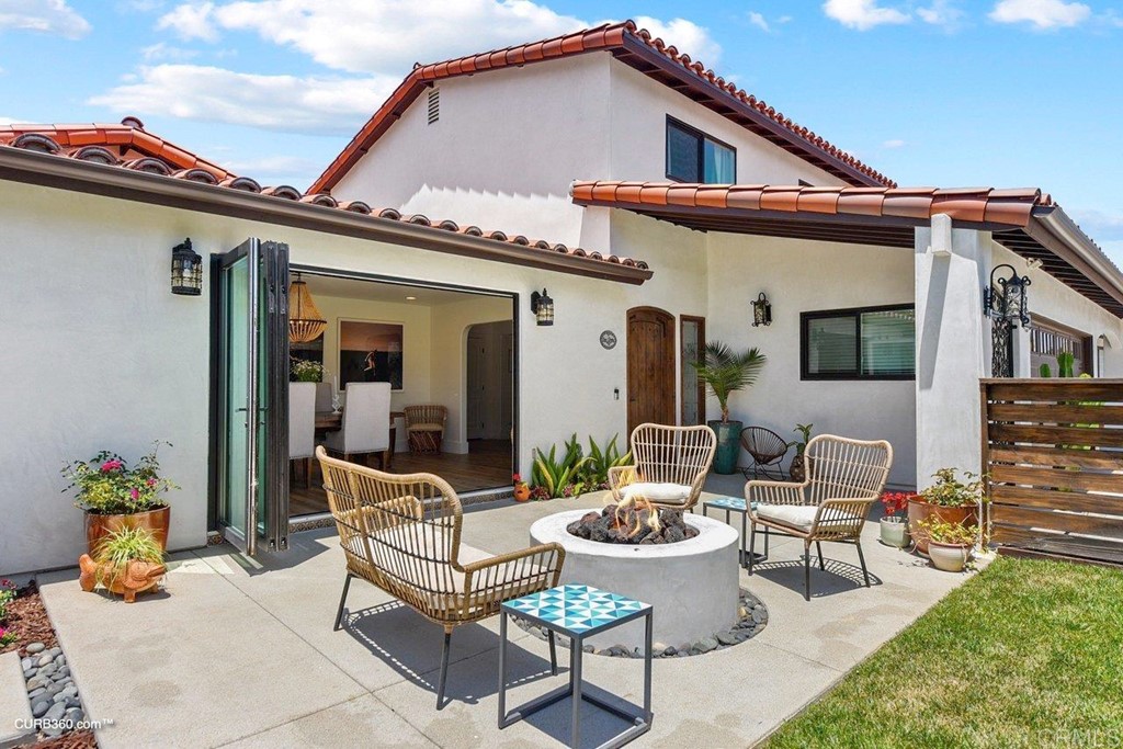 3815 Trieste Drive Carlsbad, CA 92010 - Photo 4 of 24 a view of a patio with couches table and chairs and potted plants