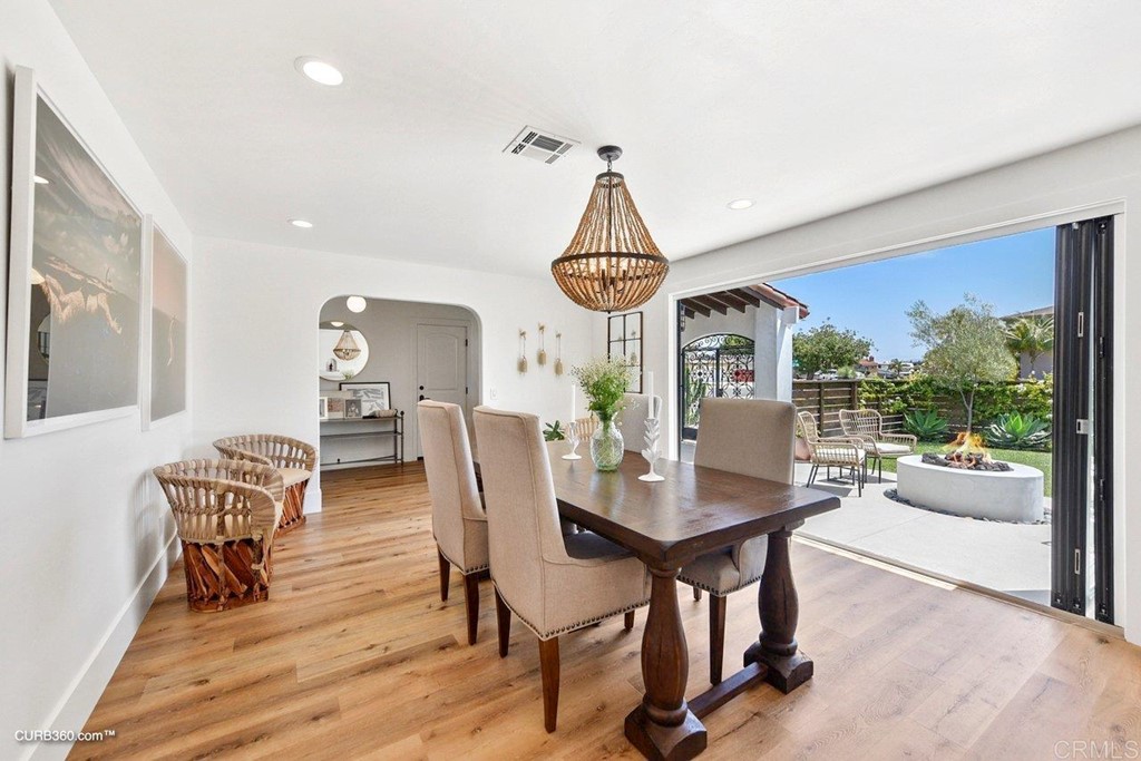 3815 Trieste Drive Carlsbad, CA 92010 - Photo 5 of 24 a view of a dining room with furniture window and wooden floor