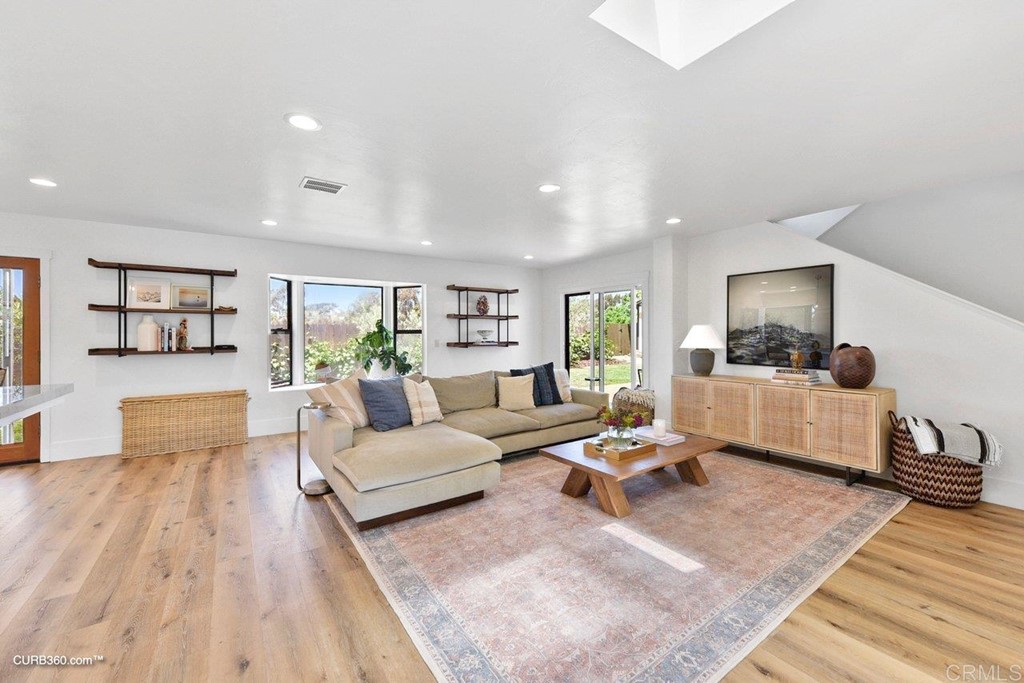 3815 Trieste Drive Carlsbad, CA 92010 - Photo 6 of 24 a living room with furniture or couch and a wooden floor