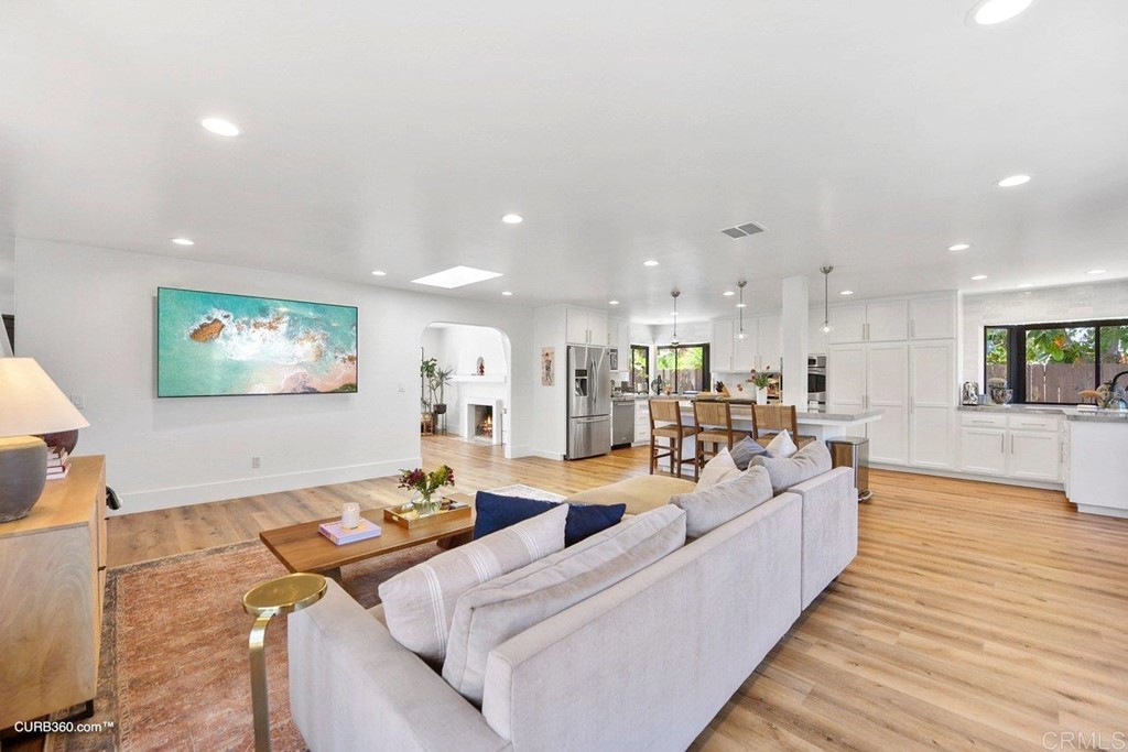 3815 Trieste Drive Carlsbad, CA 92010 - Photo 10 of 24 a living room with furniture kitchen view and a wooden floor