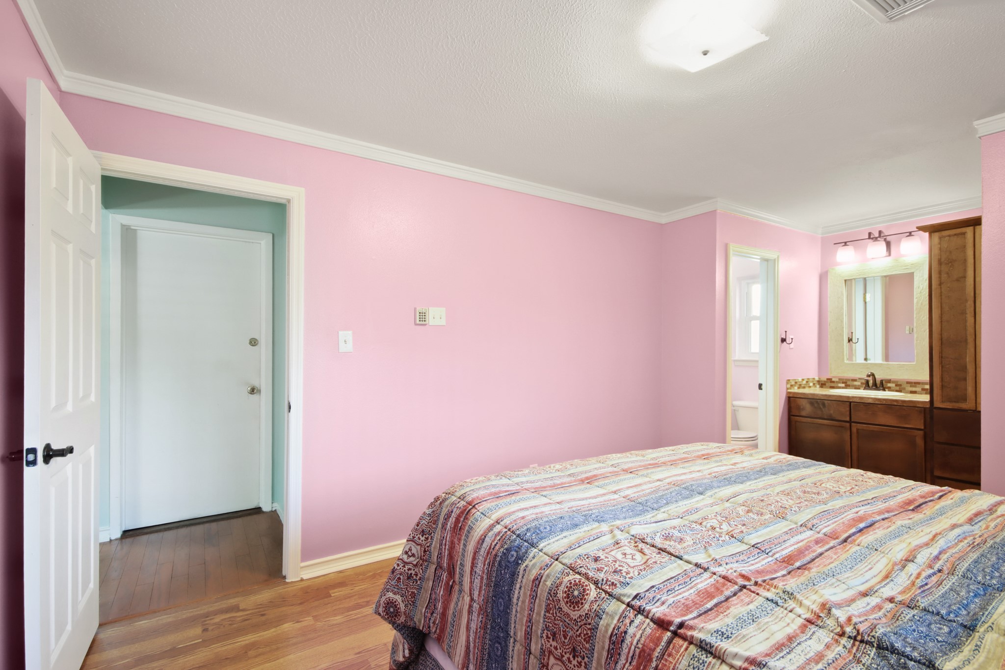 14923 Lofton Street Channelview, TX 77530 - Photo 11 of 25 a bedroom with a bed and a dresser