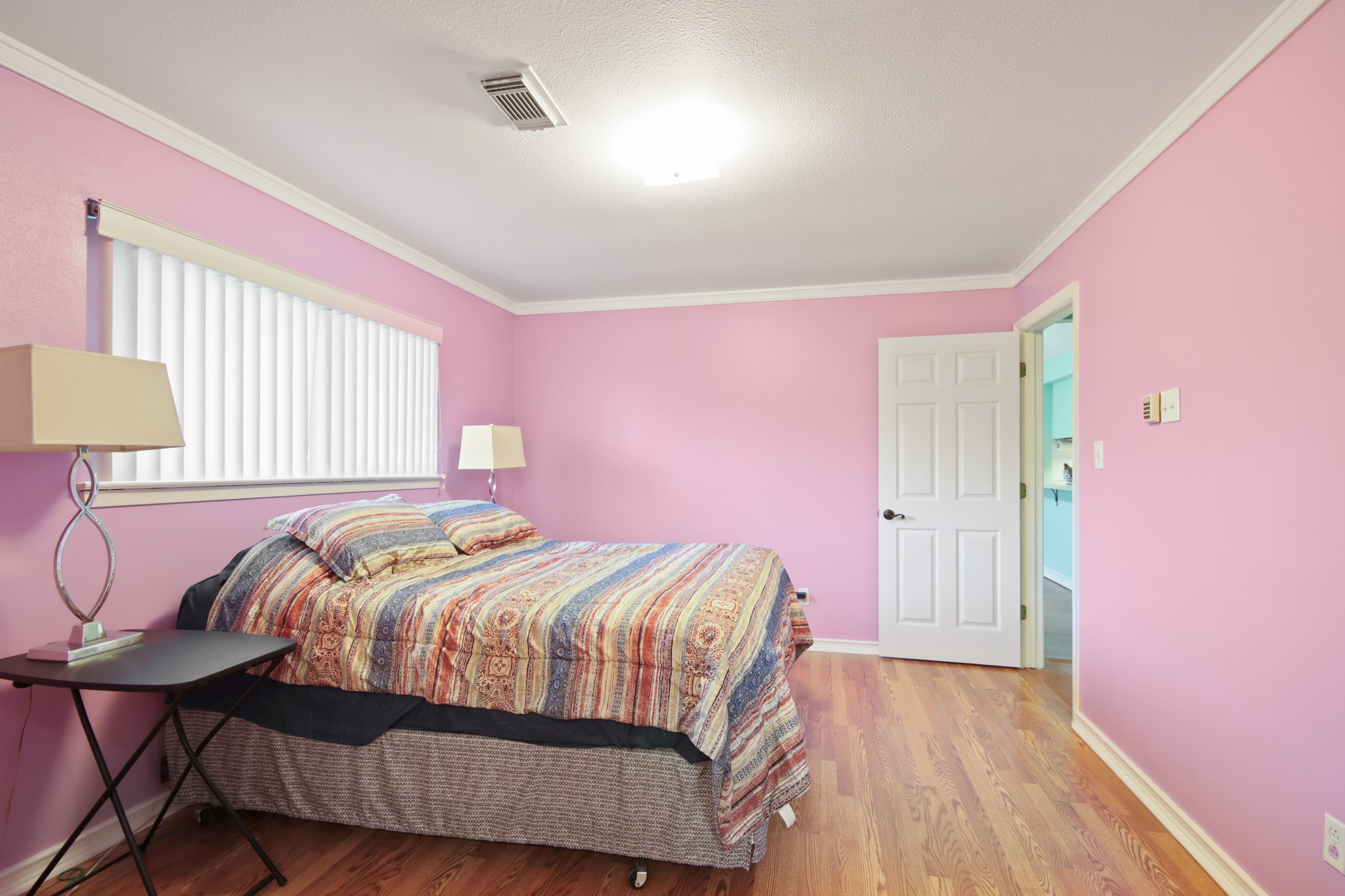 14923 Lofton Street Channelview, TX 77530 - Photo 13 of 25 a bedroom with a bed and wooden floor