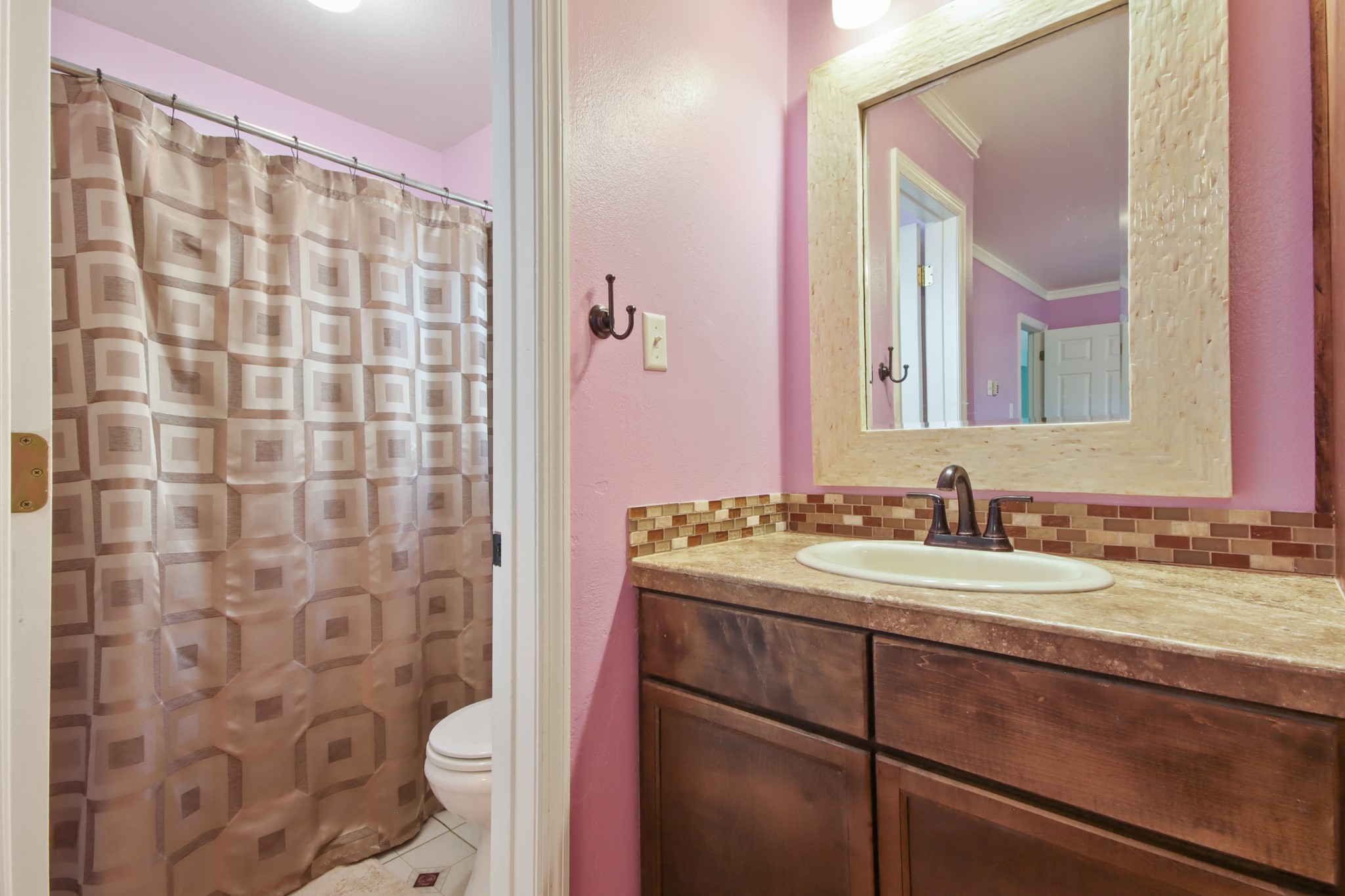 14923 Lofton Street Channelview, TX 77530 - Photo 14 of 25 a bathroom with a sink and a mirror