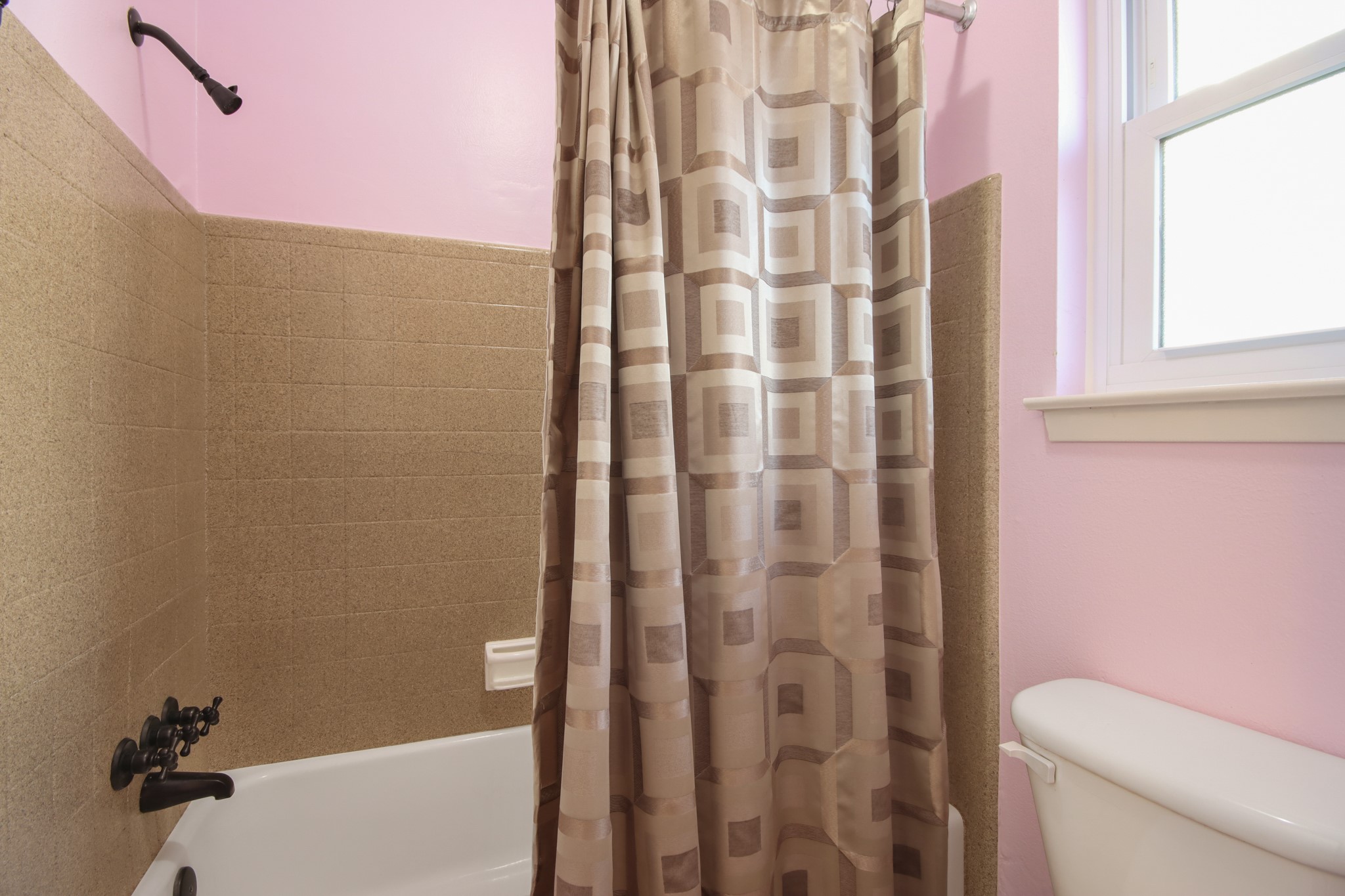 14923 Lofton Street Channelview, TX 77530 - Photo 15 of 25 a bathroom with a shower curtain and a toilet