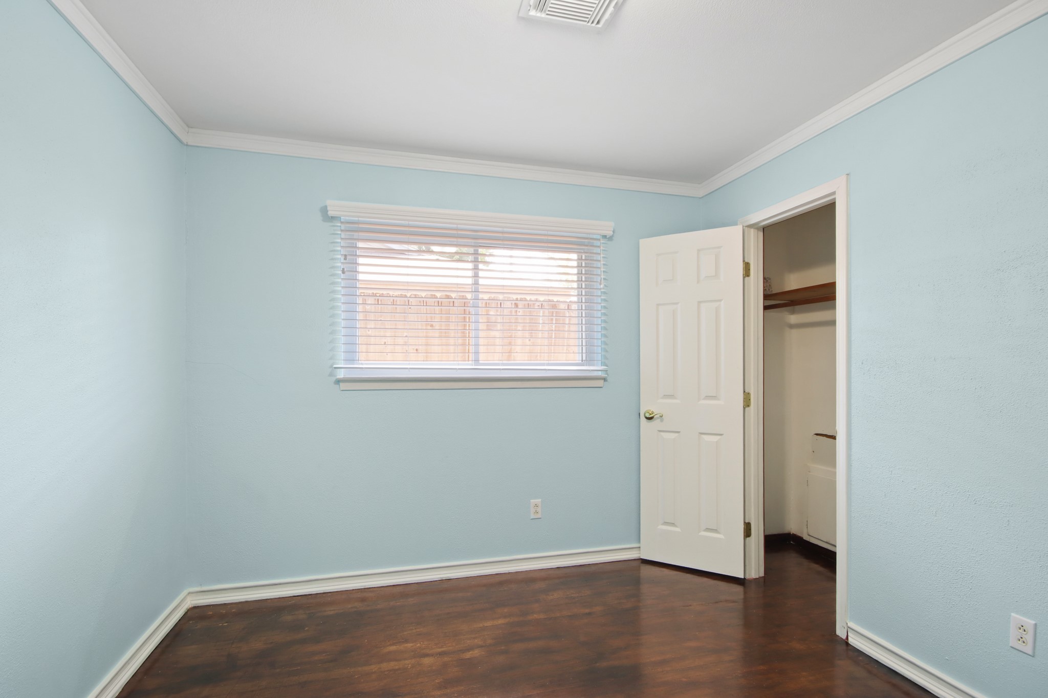 14923 Lofton Street Channelview, TX 77530 - Photo 19 of 25 an empty room with wooden floor and a window