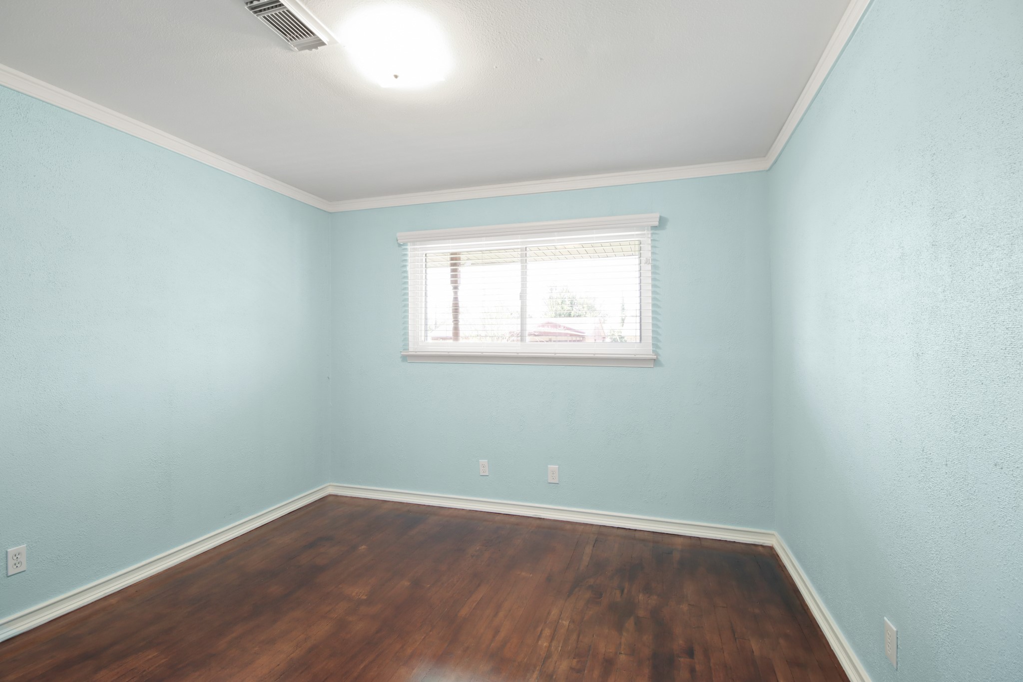 14923 Lofton Street Channelview, TX 77530 - Photo 21 of 25 an empty room with wooden floor and windows