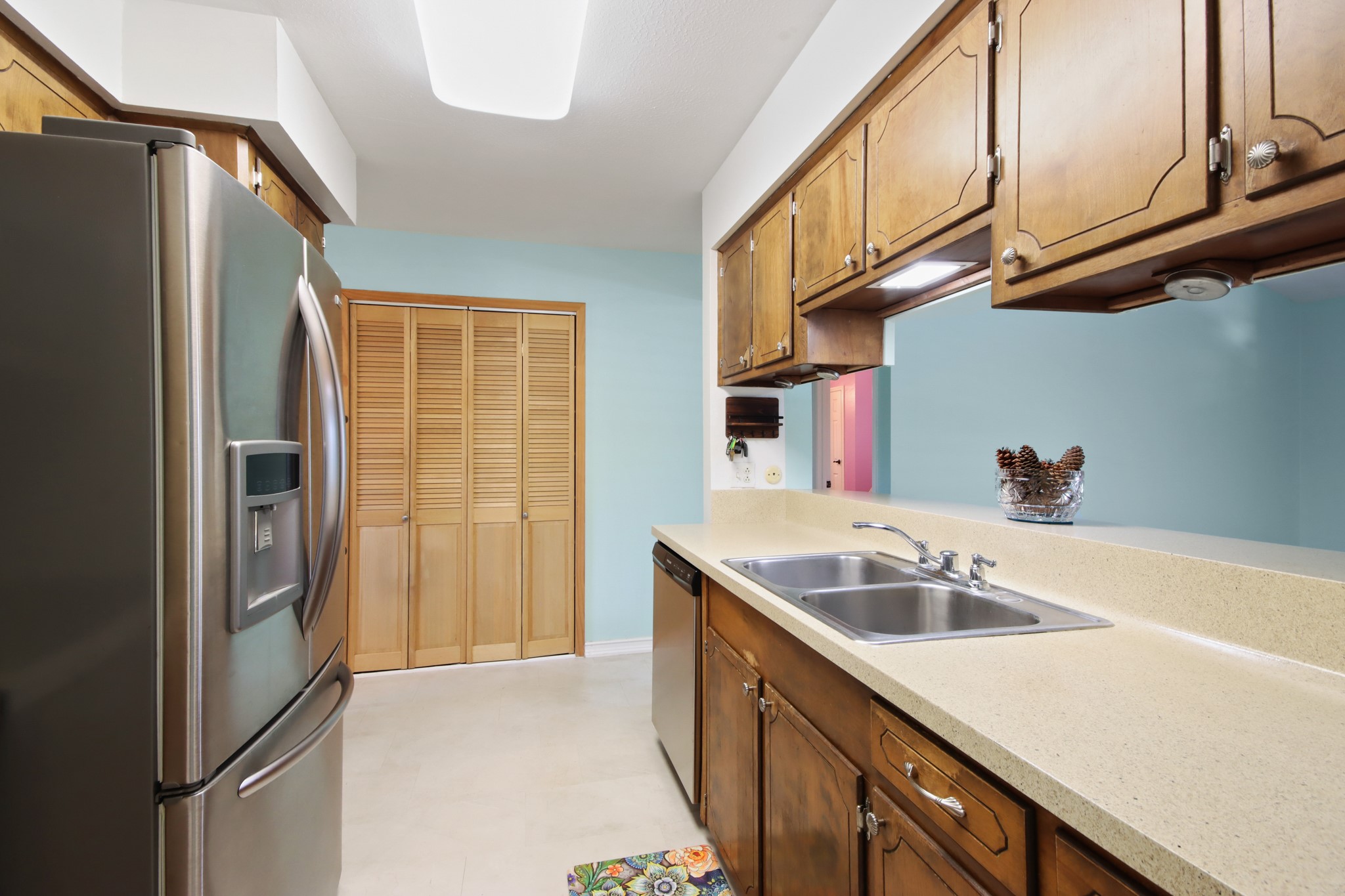 14923 Lofton Street Channelview, TX 77530 - Photo 7 of 25 a kitchen with stainless steel appliances granite countertop a sink and a refrigerator