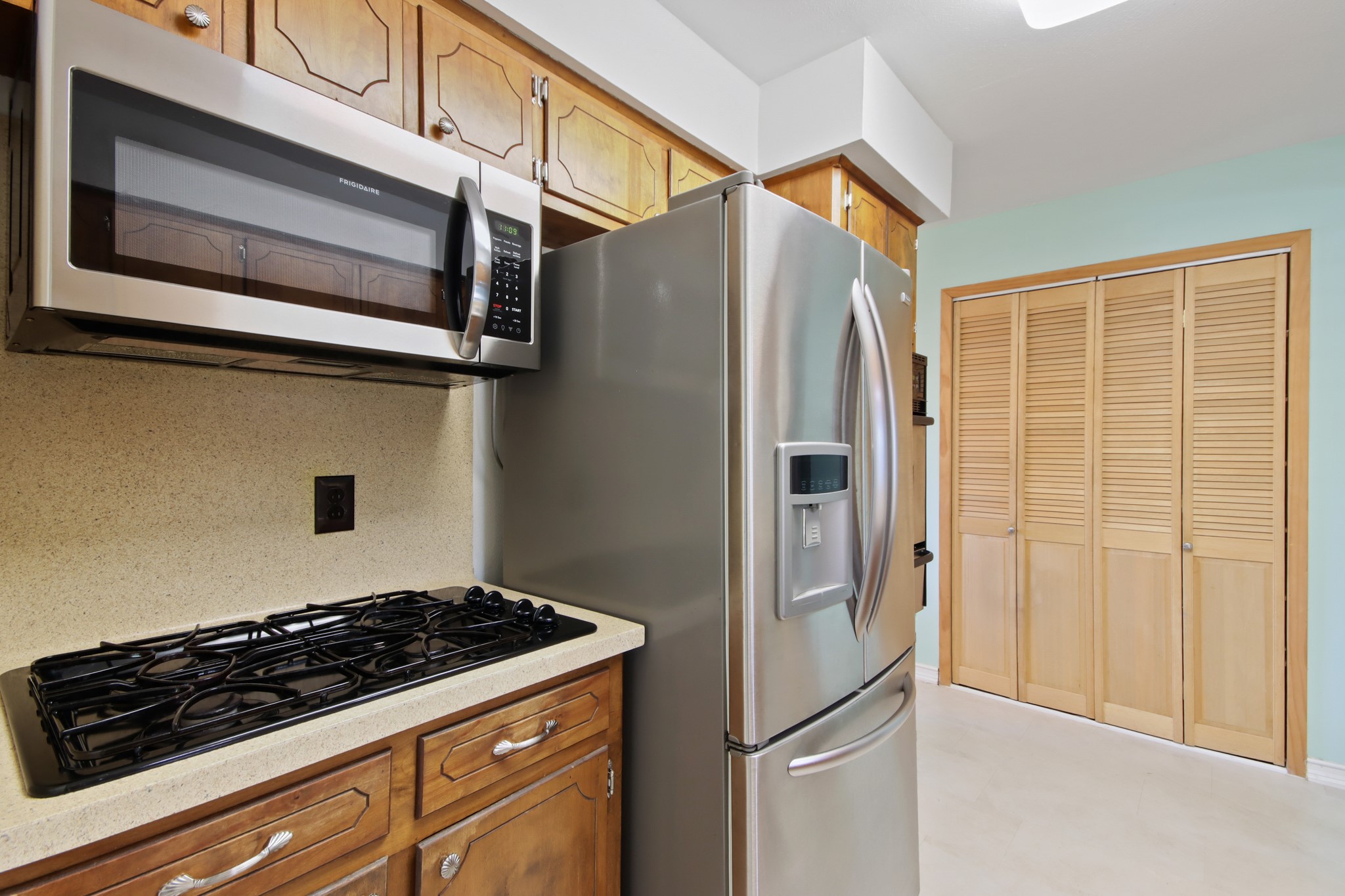 14923 Lofton Street Channelview, TX 77530 - Photo 8 of 25 a kitchen with stainless steel appliances granite countertop a refrigerator and a stove top oven
