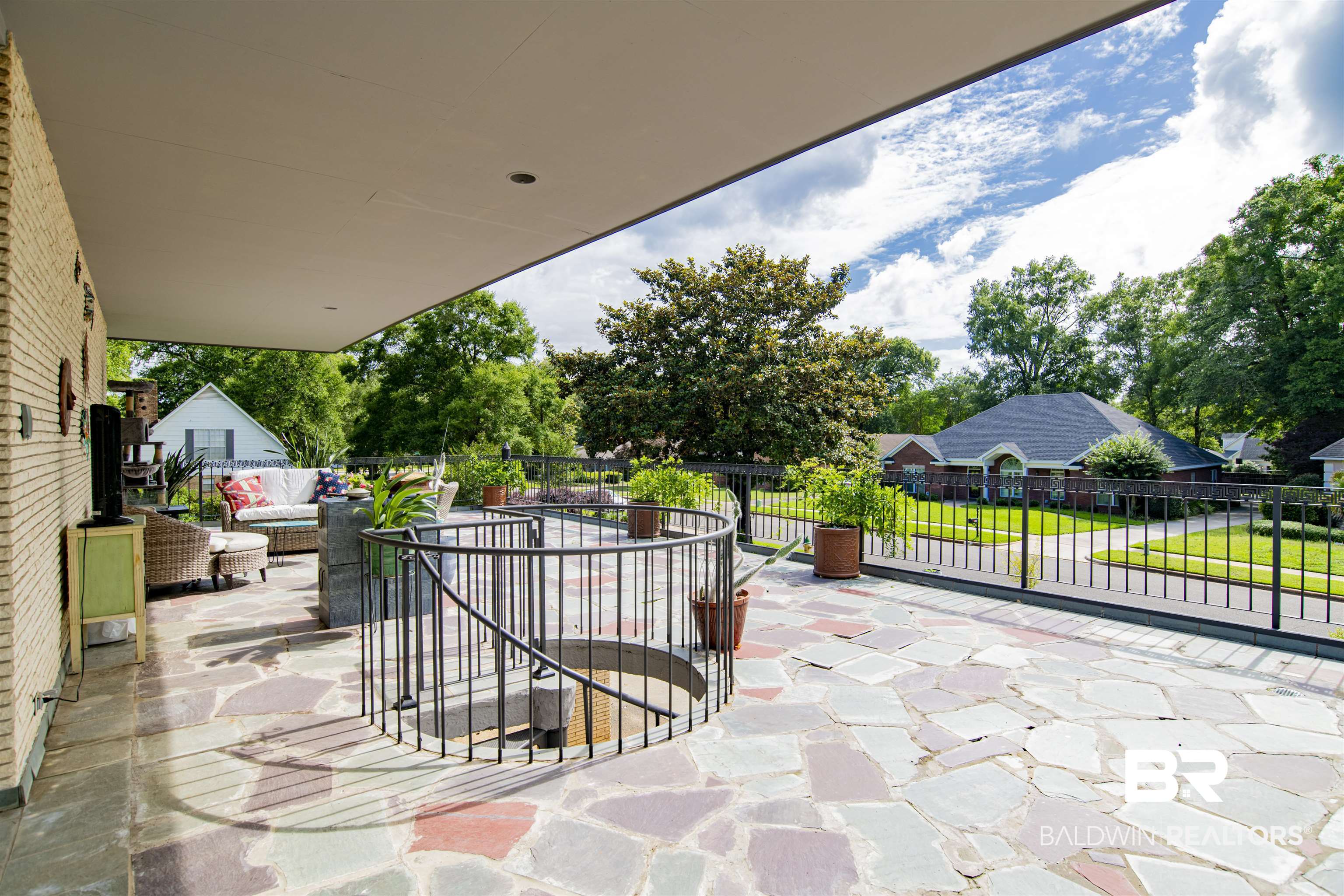 809 Bernard Circle Mobile, AL 36693 - Photo 53 of 75 Spacious outdoor patio featuring flagstone flooring, a curved wrought iron railing, and a covered section with recessed lighting